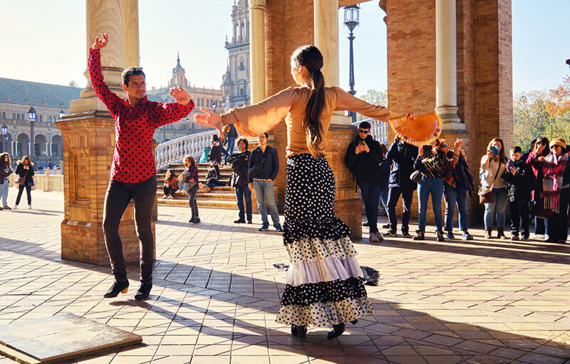 Tourists enjoy street flamenco dance show. Seville, Spain